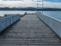 Wooden Pier on Coastal Coastline Leading to a Lake