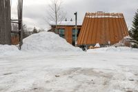 there is a building that has a wooden structure on it, with snow piled on it