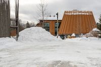 there is a building that has a wooden structure on it, with snow piled on it