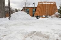 there is a building that has a wooden structure on it, with snow piled on it