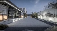 stone and concrete pathway through an outdoor area at night with lighting on the windows,