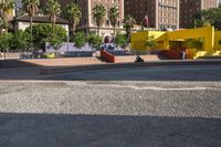 a yellow brick building sitting in the middle of a city street with tall buildings and some traffic