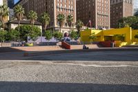 a yellow brick building sitting in the middle of a city street with tall buildings and some traffic