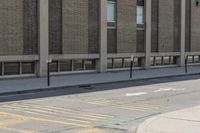 a yellow bus is parked on a street corner near buildings and a bench next to it