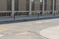 a yellow bus is parked on a street corner near buildings and a bench next to it