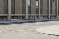 a yellow bus is parked on a street corner near buildings and a bench next to it