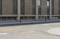 a yellow bus is parked on a street corner near buildings and a bench next to it