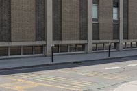 a yellow bus is parked on a street corner near buildings and a bench next to it