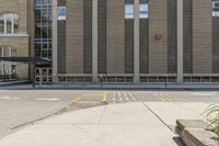 a sidewalk that has a building on top of it and no one in front with a fire hydrant on top of the sidewalk