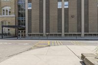 a sidewalk that has a building on top of it and no one in front with a fire hydrant on top of the sidewalk