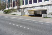 a yellow stop sign sitting on the side of a street near a building in an empty city