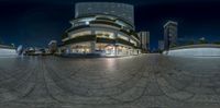 a spherical panorama of an empty street at night with traffic on the left and lights