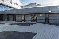 a view of an outside area of an office building with large windows and a circular driveway