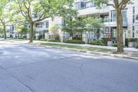 a young boy is riding a skateboard in the street while looking at the buildings