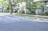 a young boy is riding a skateboard in the street while looking at the buildings