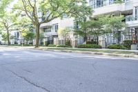 a young boy is riding a skateboard in the street while looking at the buildings