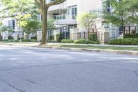 a young boy is riding a skateboard in the street while looking at the buildings