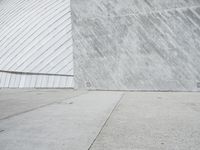 a young man skateboards past a giant screen with a photo of a shark on it