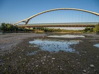 there are two very long bridges that are above the river shore at dusk here, and you can see how close them are