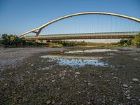 there are two very long bridges that are above the river shore at dusk here, and you can see how close them are