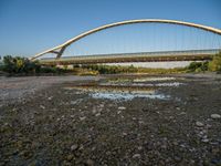 there are two very long bridges that are above the river shore at dusk here, and you can see how close them are