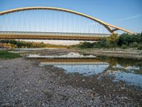 there are two very long bridges that are above the river shore at dusk here, and you can see how close them are