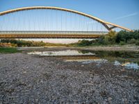 there are two very long bridges that are above the river shore at dusk here, and you can see how close them are