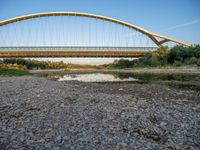 there are two very long bridges that are above the river shore at dusk here, and you can see how close them are