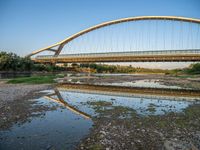 there are two very long bridges that are above the river shore at dusk here, and you can see how close them are