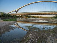 there are two very long bridges that are above the river shore at dusk here, and you can see how close them are