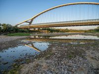 there are two very long bridges that are above the river shore at dusk here, and you can see how close them are