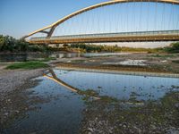 there are two very long bridges that are above the river shore at dusk here, and you can see how close them are