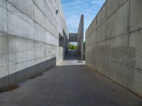 the empty parking lot in front of a wall with apartment buildings on it and a skateboarder on a ramp