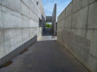 the empty parking lot in front of a wall with apartment buildings on it and a skateboarder on a ramp