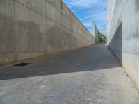 the empty parking lot in front of a wall with apartment buildings on it and a skateboarder on a ramp