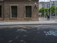 the side walk and walkway of a building is marked with markings for parking spaces below