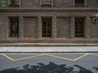 the side walk and walkway of a building is marked with markings for parking spaces below