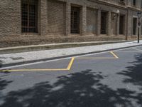 the side walk and walkway of a building is marked with markings for parking spaces below