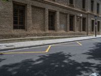 the side walk and walkway of a building is marked with markings for parking spaces below