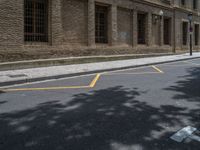 the side walk and walkway of a building is marked with markings for parking spaces below