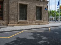 the side walk and walkway of a building is marked with markings for parking spaces below