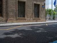 the side walk and walkway of a building is marked with markings for parking spaces below