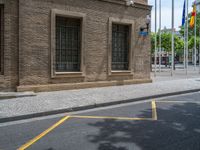 the side walk and walkway of a building is marked with markings for parking spaces below