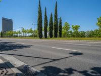 a concrete structure made into rows of orange and yellow poles are on a cement sidewalk