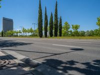 a concrete structure made into rows of orange and yellow poles are on a cement sidewalk