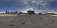 a view from a 360 - eye lens is shown of an empty road and city buildings