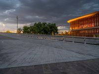 there is a large cement bridge over the road on a cloudy day with tall buildings in the background