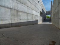 the empty parking lot in front of a wall with apartment buildings on it and a skateboarder on a ramp