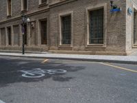 the side walk and walkway of a building is marked with markings for parking spaces below