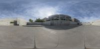 a skateboarder is riding down the cement ramp with another skateboard in front of him